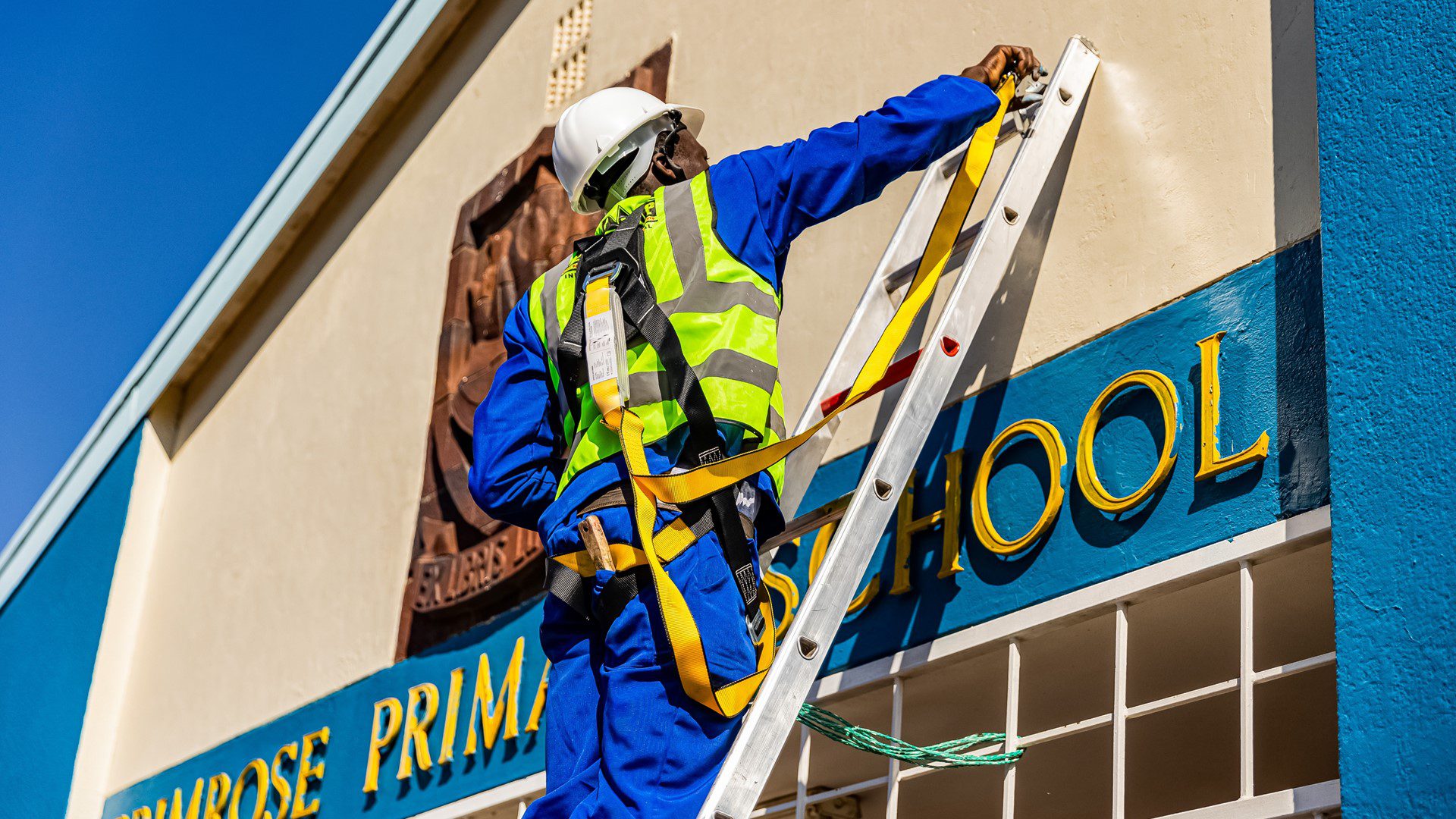 Employees applying repairs on rooftop in community project