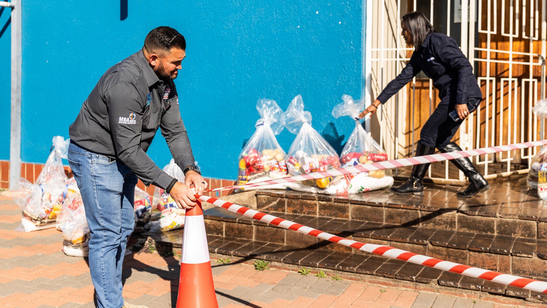 Volunteer distributing food parcels during Sicon Groups community initiative