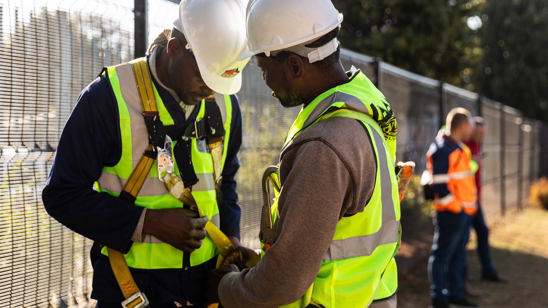 Two staff members working on rooftop repairs for a CSI project