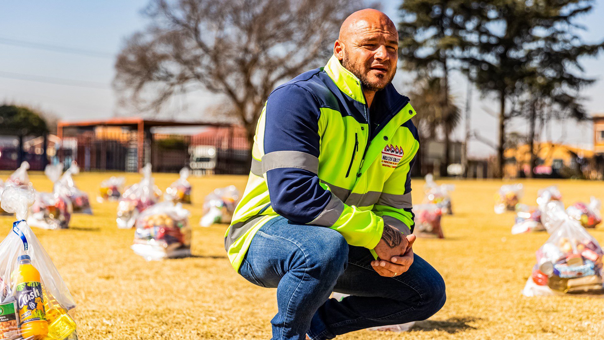 Staff lined up during community roofing project