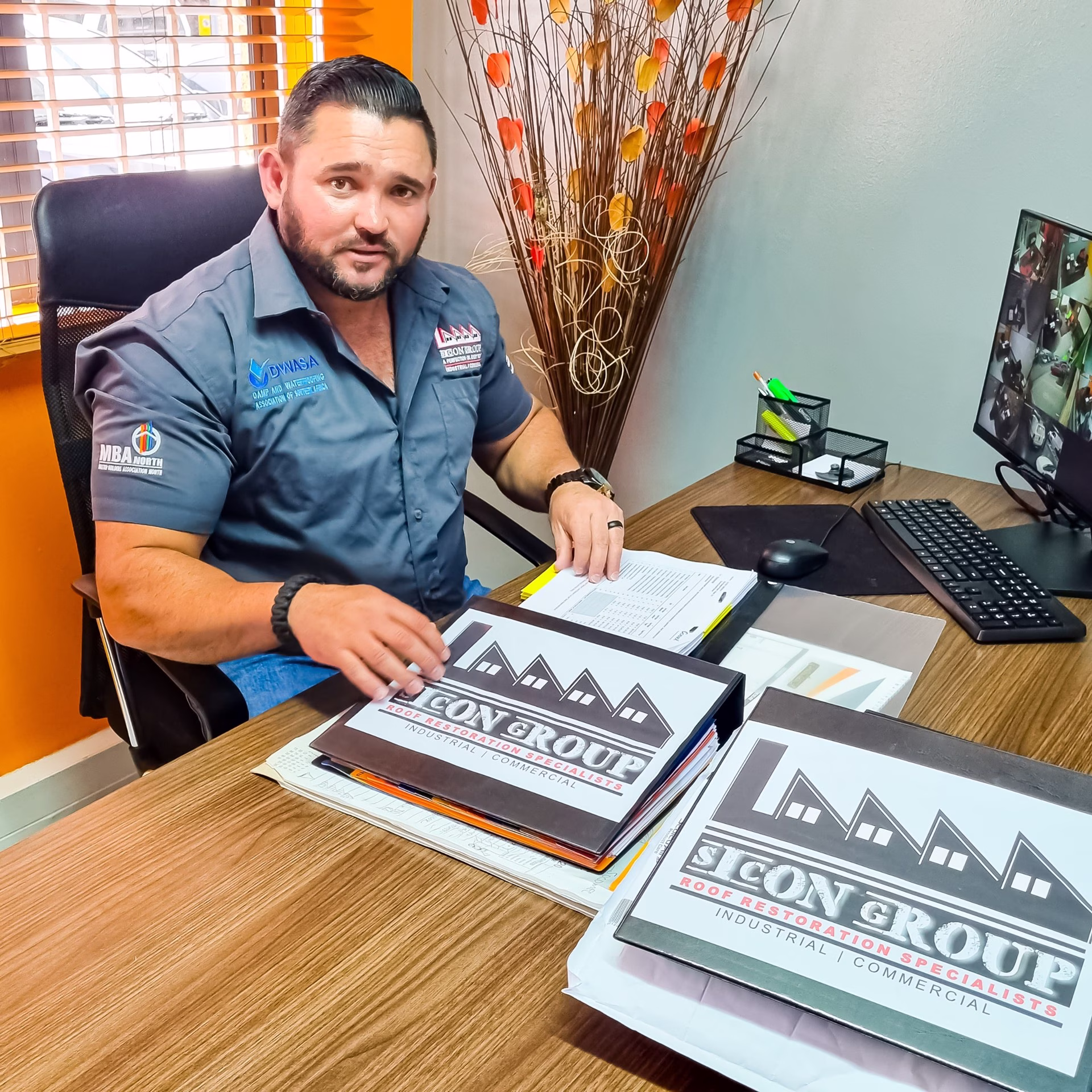 Sicon team leader at his desk going through project files and proposals