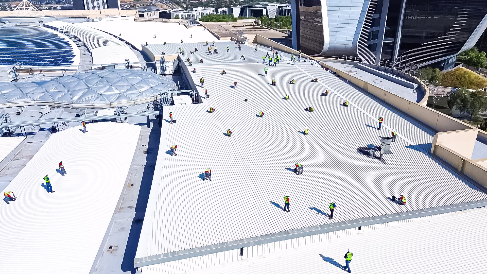 Professional roofing company in Johannesburg repairing an industrial warehouse roof.
