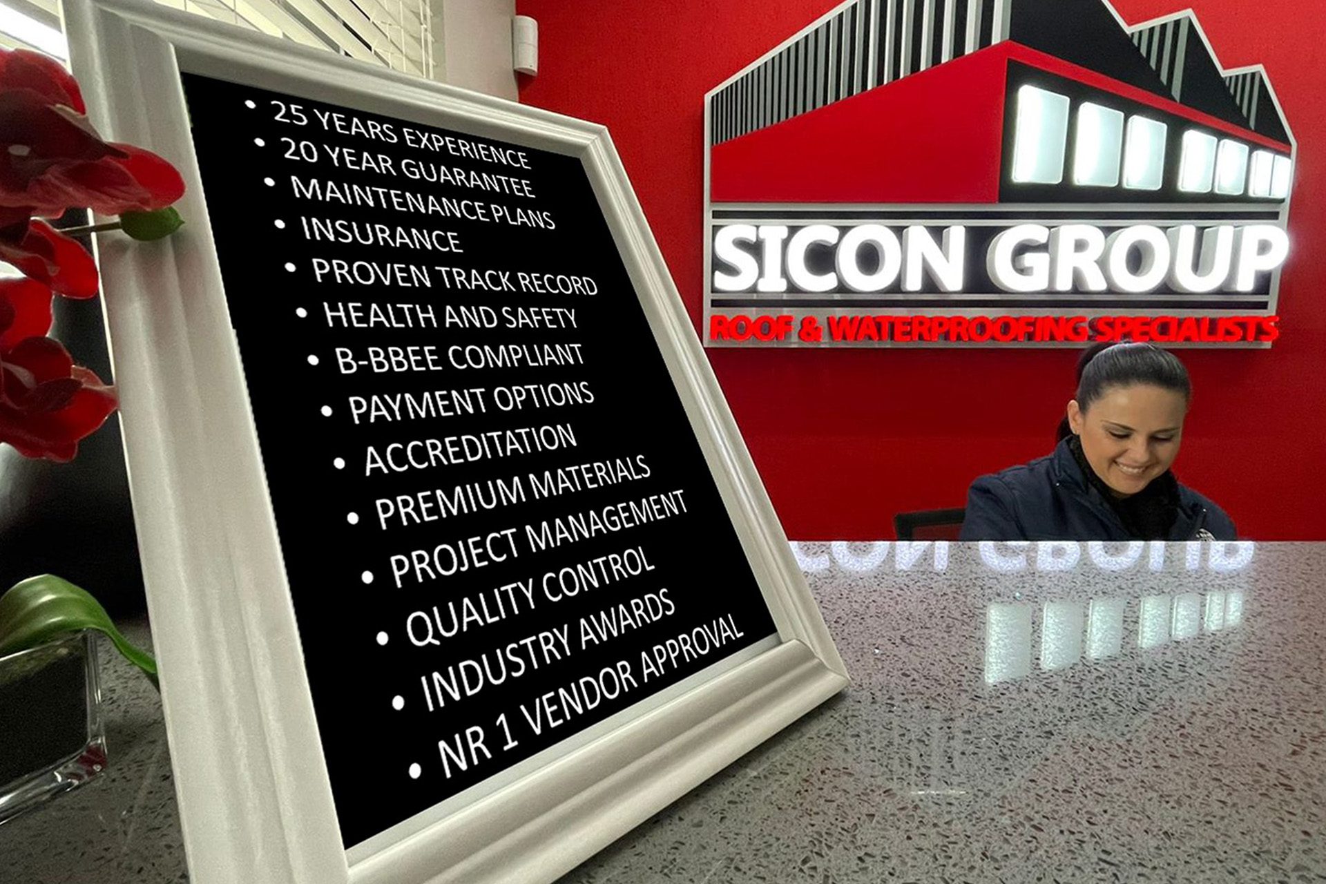 Reception desk at Sicon Group Gauteng showcasing a framed list of credentials, accreditations and service promises